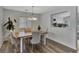 Stylish dining room with a modern chandelier, hardwood floors, and ample natural light at 7838 Long Shadow Ln, North Charleston, SC 29406