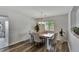 Cozy dining room with elegant lighting, hardwood floors, and a view of the backyard at 7838 Long Shadow Ln, North Charleston, SC 29406
