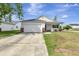 Inviting single-story home featuring an attached garage, driveway, and a quaint front porch at 7838 Long Shadow Ln, North Charleston, SC 29406