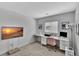 Home office space with white desk, rolling chair, and wall mounted television at 7838 Long Shadow Ln, North Charleston, SC 29406