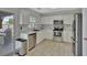 A modern kitchen with stainless steel appliances, white cabinetry, and granite countertops provides a delightful cooking space at 7838 Long Shadow Ln, North Charleston, SC 29406