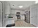This kitchen boasts white cabinets, marble-style countertops, and stainless steel appliances, creating a clean and contemporary aesthetic at 7838 Long Shadow Ln, North Charleston, SC 29406