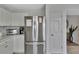 A spacious kitchen featuring white cabinets, stainless steel refrigerator, and marble style countertops for a modern, elegant design at 7838 Long Shadow Ln, North Charleston, SC 29406
