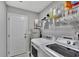 Laundry room with a modern washer and dryer and ample storage shelving at 7838 Long Shadow Ln, North Charleston, SC 29406