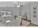Spacious living room filled with natural light, featuring contemporary white furniture, and hardwood flooring at 7838 Long Shadow Ln, North Charleston, SC 29406
