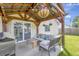 Covered patio with grill, seating, and stylish decor for outdoor entertaining at 7838 Long Shadow Ln, North Charleston, SC 29406