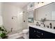 Modern bathroom with herringbone tile, dual sink vanity, glass enclosed shower, and elegant fixtures at 82 Ponsbury Rd, Mount Pleasant, SC 29464