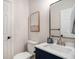 This bathroom features a white sink, a framed picture, and a white toilet at 82 Ponsbury Rd, Mount Pleasant, SC 29464