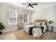 Bright bedroom with natural light, modern ceiling fan, decorative shelf, and light wood flooring at 82 Ponsbury Rd, Mount Pleasant, SC 29464