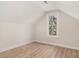 This bedroom features light-colored wood floors, a sloped roof, and a small window at 82 Ponsbury Rd, Mount Pleasant, SC 29464