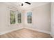 This bedroom features two windows, light-colored walls, and light-colored wood floors at 82 Ponsbury Rd, Mount Pleasant, SC 29464