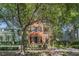 Charming two-story home with wood siding, a covered balcony, and lush landscaping at 82 Ponsbury Rd, Mount Pleasant, SC 29464