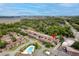 Aerial view of a complex with a pool, surrounded by trees and a marshy body of water in the distance at 867 Colony Dr # F92, Charleston, SC 29407