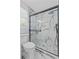 Stunning bathroom featuring a glass shower with white marble-patterned tiles, and mosaic tile flooring at 867 Colony Dr # F92, Charleston, SC 29407