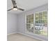 Bright bedroom with a ceiling fan, light wood flooring, and a large window with blinds at 867 Colony Dr # F92, Charleston, SC 29407