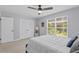 Bright bedroom featuring a queen-sized bed, ceiling fan, closet, and large window for natural light at 867 Colony Dr # F92, Charleston, SC 29407