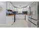 Well-equipped kitchen with sleek white cabinets, modern appliances, and stylish backsplash at 867 Colony Dr # F92, Charleston, SC 29407