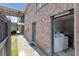 Exterior view of a laundry room facility for a brick apartment building with two washing machines at 867 Colony Dr # F92, Charleston, SC 29407