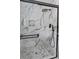 A shower with white marble-patterned tiles, black trim, rain shower head, and mosaic tile floor at 867 Colony Dr # F92, Charleston, SC 29407