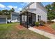 Home's backyard with patio, screened-in porch and tidy landscaping at 8987 Planters Row Ln, Summerville, SC 29485