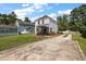 Home's backyard features green lawn, patio, screened-in porch and driveway at 8987 Planters Row Ln, Summerville, SC 29485