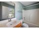 Bright bathroom with a shower and tub combination and a stylish, framed mirror above the vanity at 8987 Planters Row Ln, Summerville, SC 29485