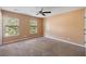Spacious bedroom with plush carpeting, neutral walls, and natural light from two windows at 8987 Planters Row Ln, Summerville, SC 29485