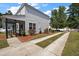 Wide driveway leads to home with screened-in porch and landscaped yard at 8987 Planters Row Ln, Summerville, SC 29485