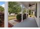 Covered front porch with pillars and ceiling fan overlooking landscaped yard at 8987 Planters Row Ln, Summerville, SC 29485