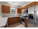 Modern kitchen with stainless steel appliances, light countertops, and gray tiled backsplash at 8987 Planters Row Ln, Summerville, SC 29485