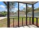 View from screened porch shows fenced backyard with grass and mulch at 8987 Planters Row Ln, Summerville, SC 29485