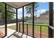 View from screened porch shows fenced backyard with grass and patio at 8987 Planters Row Ln, Summerville, SC 29485