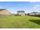 Large, expansive backyard with green grass and a view of the rear of the home at 9009 Chato Ct, Summerville, SC 29483