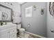 Half bath with a stylish mirror, modern fixtures, and soft lighting at 9009 Chato Ct, Summerville, SC 29483