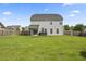 View of the home's rear exterior with large backyard and patio with hot tub at 9009 Chato Ct, Summerville, SC 29483