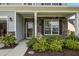 Inviting front porch with stone accents, decorative landscaping, and charming decor at 9009 Chato Ct, Summerville, SC 29483
