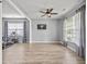 Open living room with wood floors, large windows, and views to a second room at 9009 Chato Ct, Summerville, SC 29483