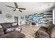 Inviting living room featuring a statement wall, wood floors, and comfortable seating at 9009 Chato Ct, Summerville, SC 29483