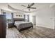 Well-lit main bedroom boasts hardwood floors, ceiling fan, and large windows at 9009 Chato Ct, Summerville, SC 29483