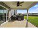 Outdoor patio with ceiling fan, grill and hot tub overlooking a green lawn at 9009 Chato Ct, Summerville, SC 29483