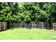 Spacious backyard with lush green lawn and privacy fence, great for outdoor activities at 9694 Roseberry St, Ladson, SC 29456