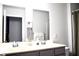 Bathroom features a double sink vanity and large mirrors with neutral wall color at 9694 Roseberry St, Ladson, SC 29456