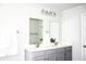 Bright bathroom features a double sink vanity with two mirrors and modern lighting at 9694 Roseberry St, Ladson, SC 29456