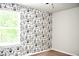 Modern bedroom with unique wallpaper and window view featuring natural light at 9694 Roseberry St, Ladson, SC 29456