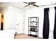 Bright bedroom features dark curtains, a ceiling fan, and built in shelving for storage at 9694 Roseberry St, Ladson, SC 29456