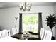 Bright dining room features a modern chandelier, gray curtains and a sliding glass door at 9694 Roseberry St, Ladson, SC 29456