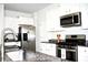Modern kitchen featuring stainless steel appliances, granite countertops and white cabinets at 9694 Roseberry St, Ladson, SC 29456