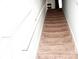 Carpeted staircase with white railing provides access to the upper level of the home at 9694 Roseberry St, Ladson, SC 29456