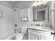 Well-lit bathroom with a white subway tile shower/tub and a granite-topped vanity at 6 Kirkland Ln, Charleston, SC 29401