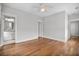 Spacious bedroom featuring hardwood floors, ceiling fan, and a door leading to the bathroom at 6 Kirkland Ln, Charleston, SC 29401